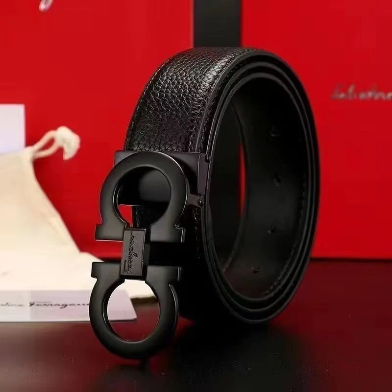 Black leather belt with a prominent buckle on a red background