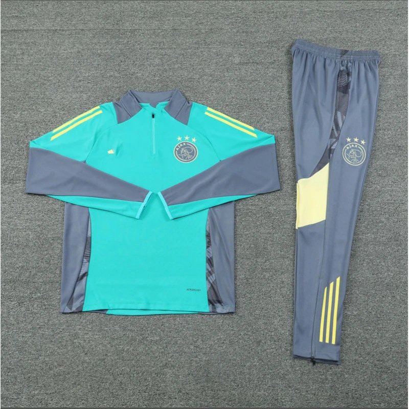 Teal and gray tracksuit with yellow accents on a gray background