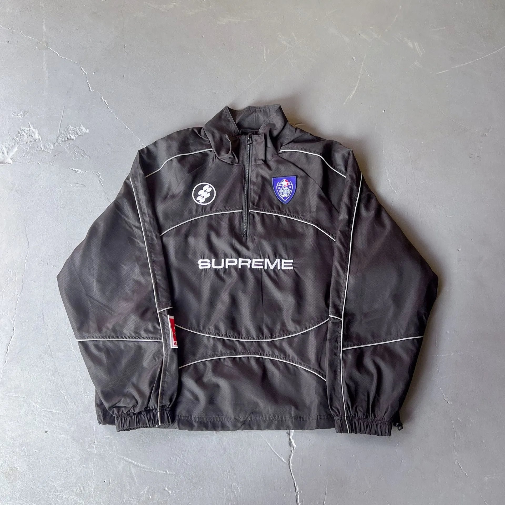 Dark gray jacket with brand logo on a gray background