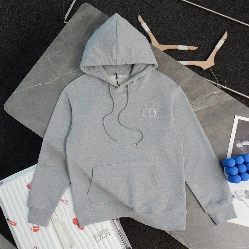 Gray hoodie on a dark surface with a pen and blueberries