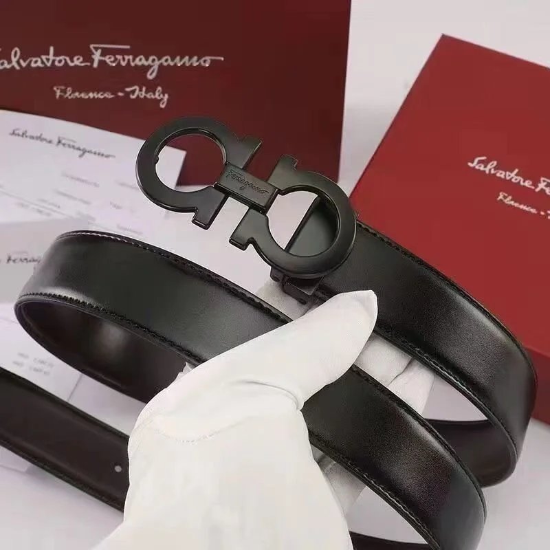 Black Ferragamo belt with gold logo on a white background