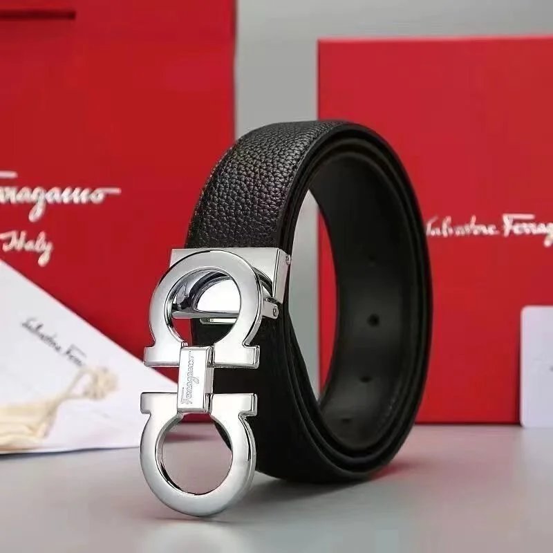 Black belt with silver buckle in front of Salvatore Ferragamo packaging