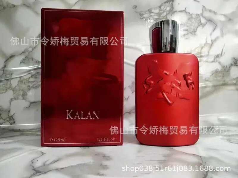 Red perfume bottle and packaging with 'KALAN' branding on a marble surface.
