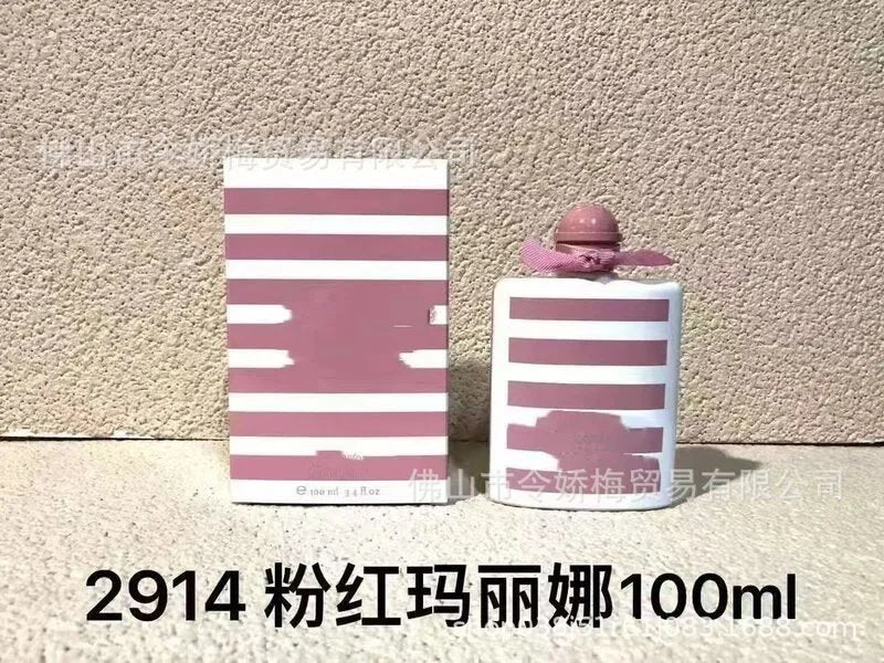 Pink and white striped bottle and packaging against a beige wall.