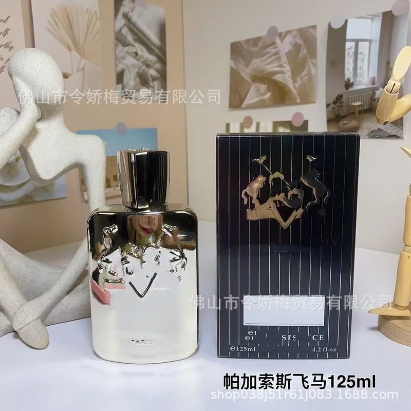 Perfume bottle and packaging with 'Royal Essence' branding on a table.