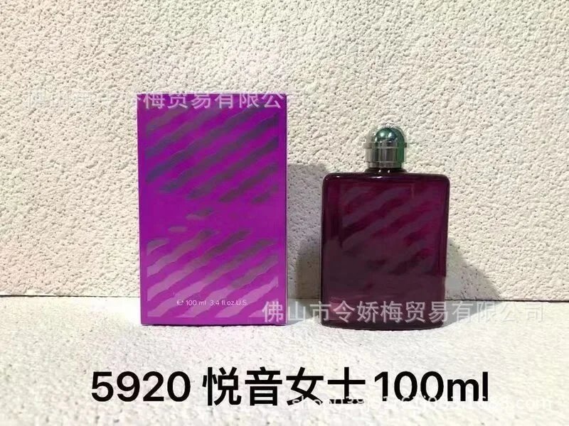Purple perfume bottle and packaging with text on a textured wall background
