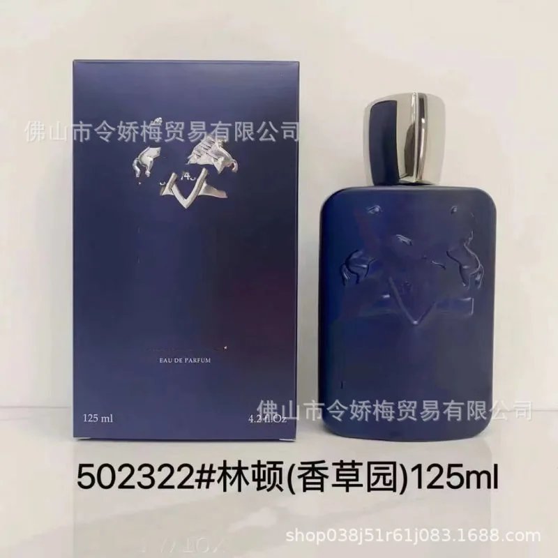 Blue perfume bottle and packaging with embossed design on a light gray background