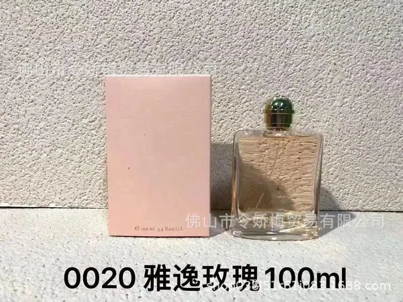 Perfume bottle and packaging on a textured surface