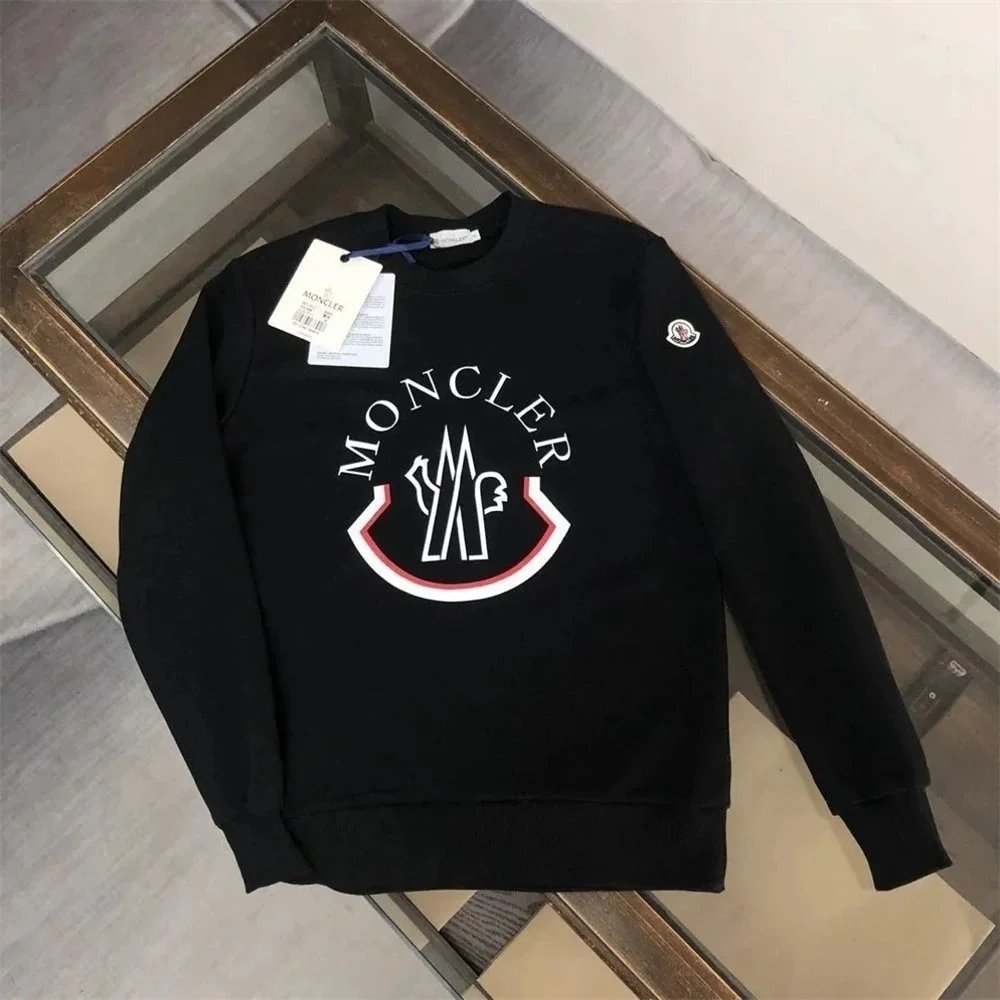 Black Moncler sweatshirt with logo on a reflective surface