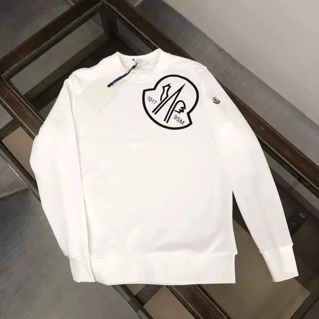 White sweatshirt with a logo on a wooden surface
