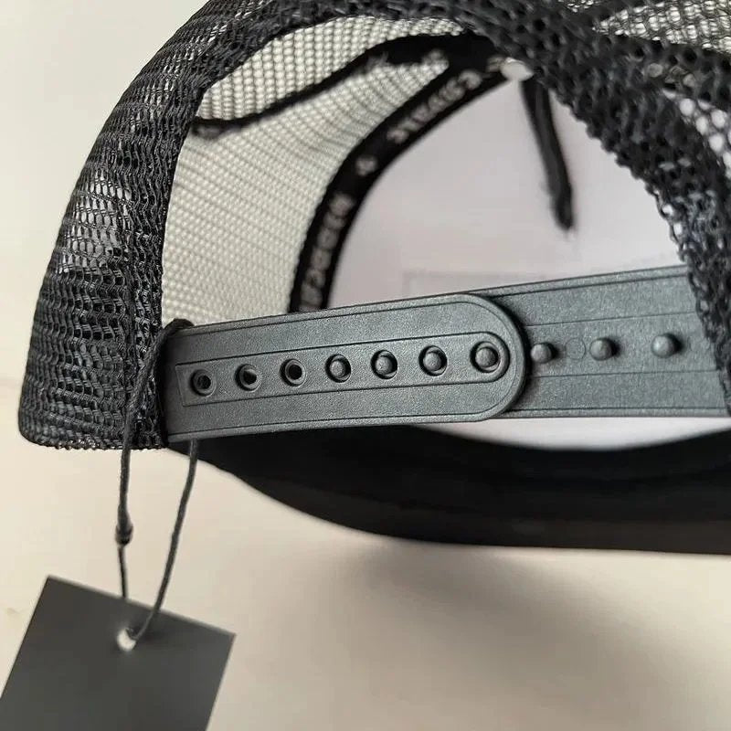 Black mesh cap with a gray brim on a light background