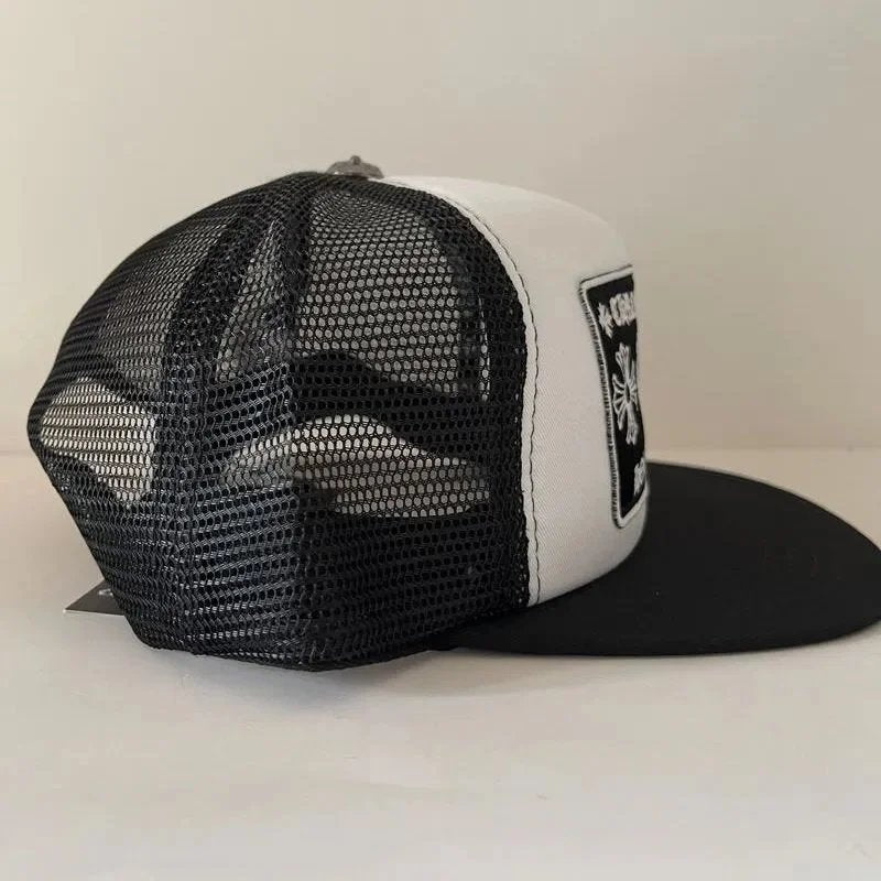 Black and white trucker cap with mesh back on a light gray background