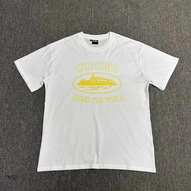 White t-shirt with yellow graphic and text on a gray textured background
