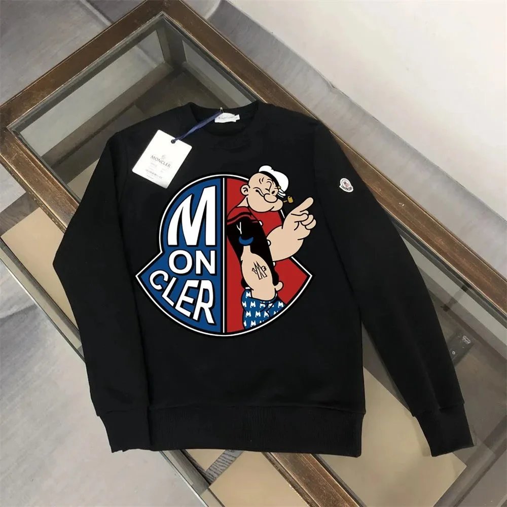 Black sweatshirt with colorful graphic design on a wooden floor