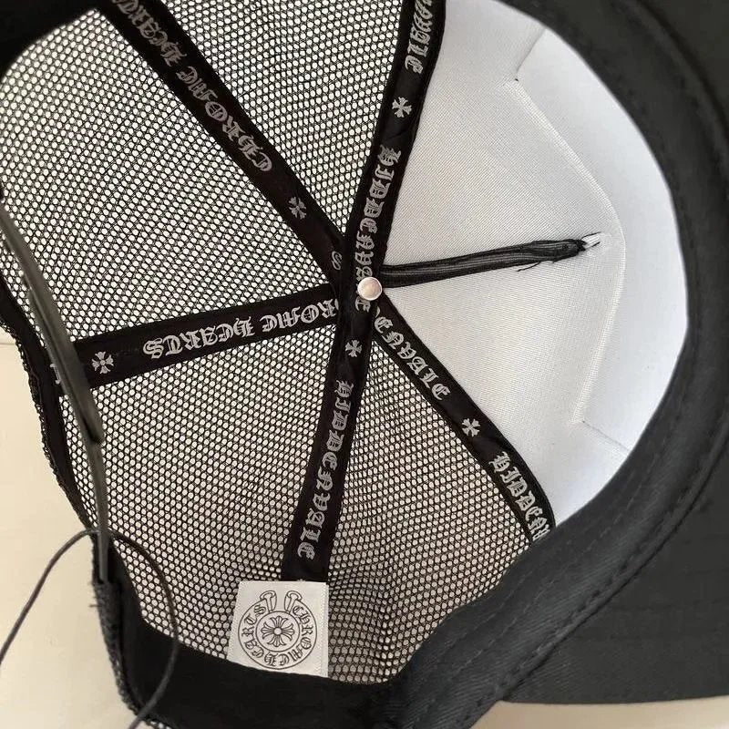 Close-up of a black and white cap with mesh back and brand logo.