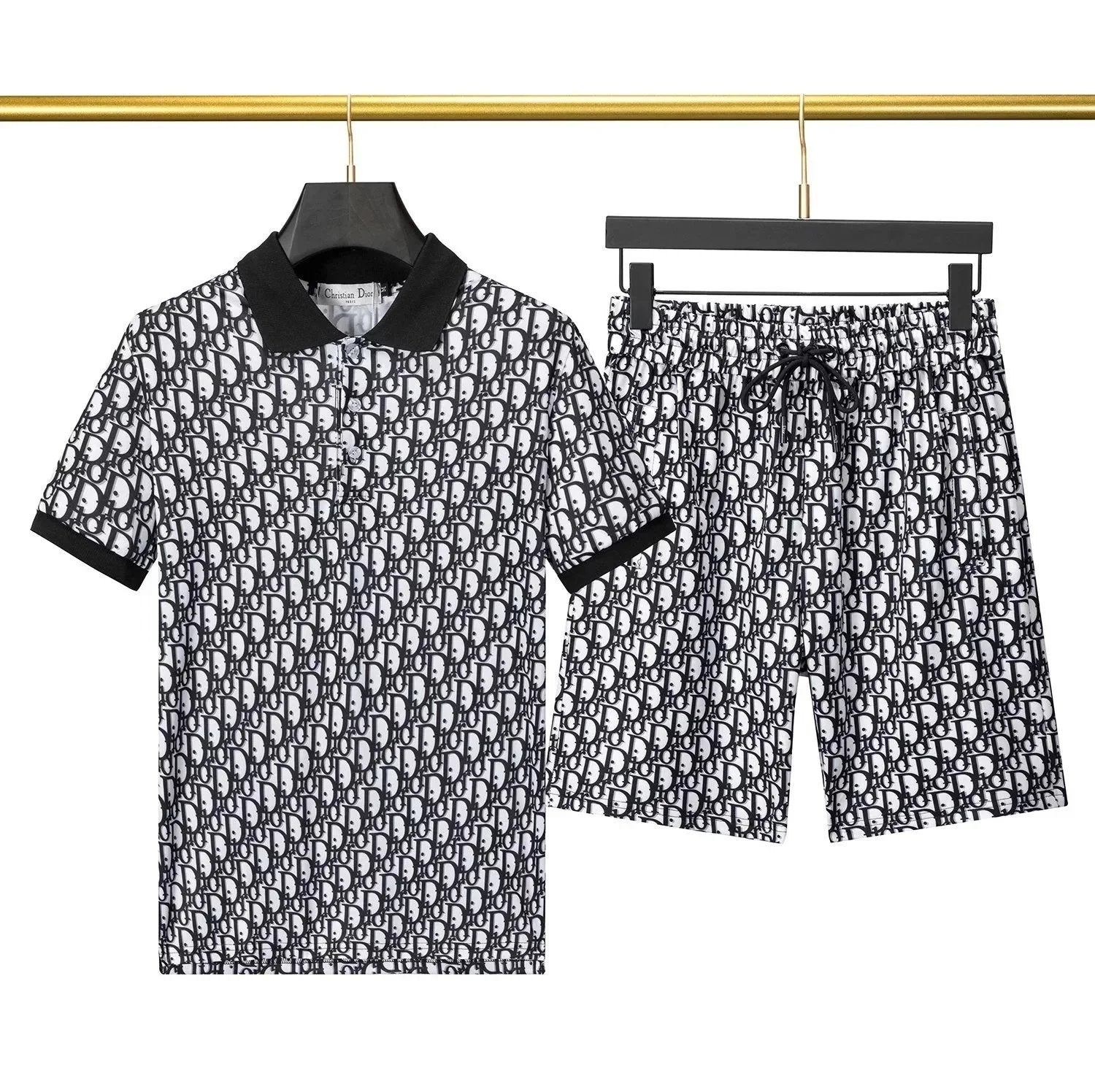Black and white patterned shirt and shorts set on hangers against a neutral background