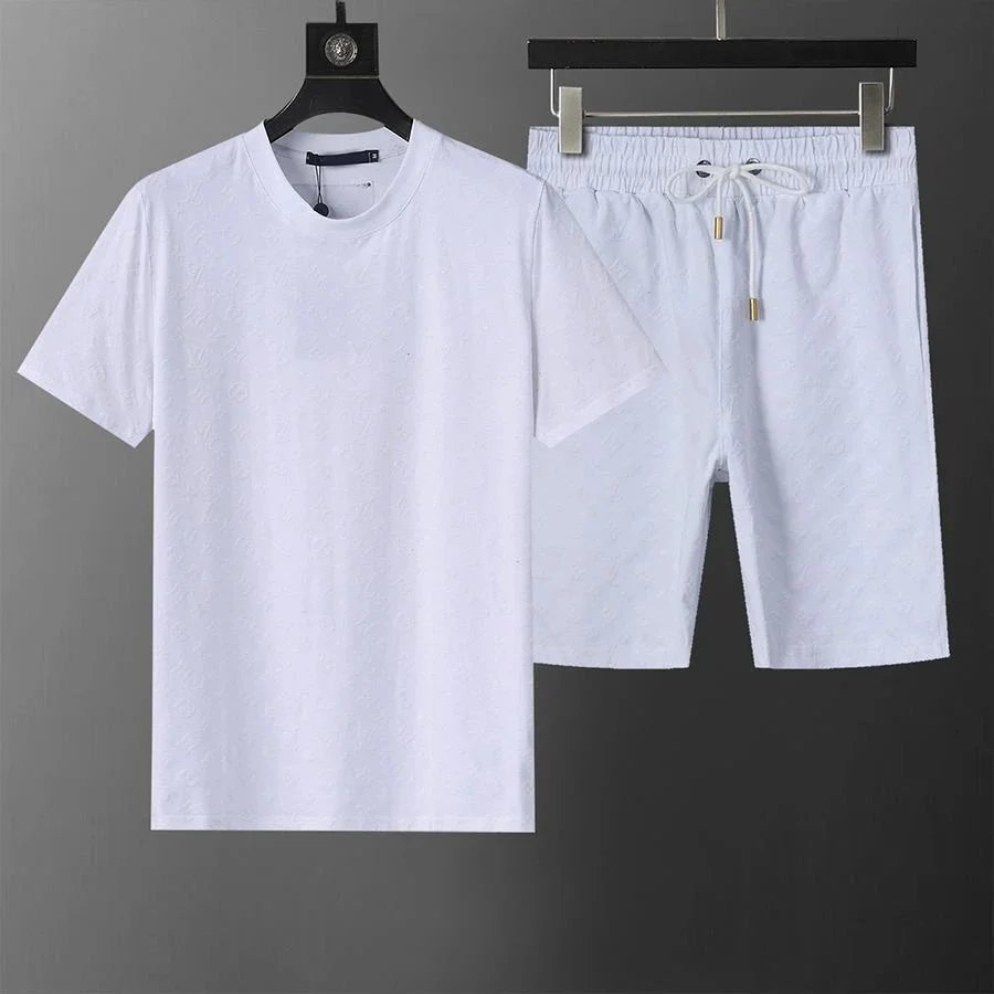 White t-shirt and shorts set on hangers against a gray background