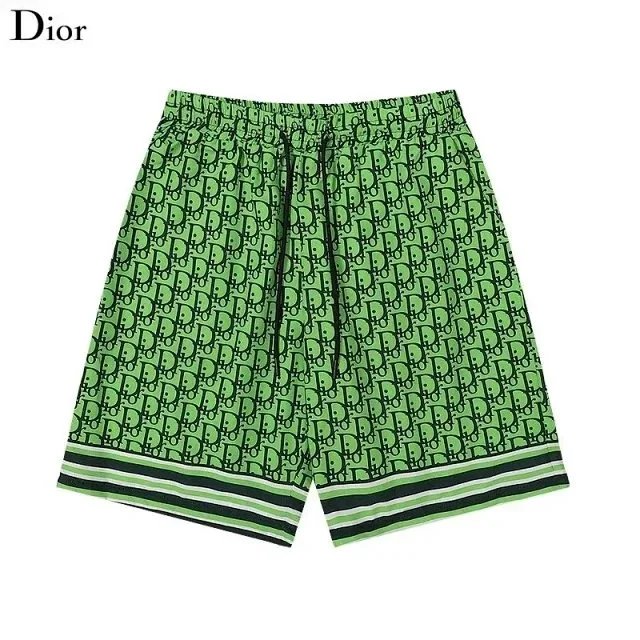Green shorts with a pattern on a white background, featuring the Dior logo.