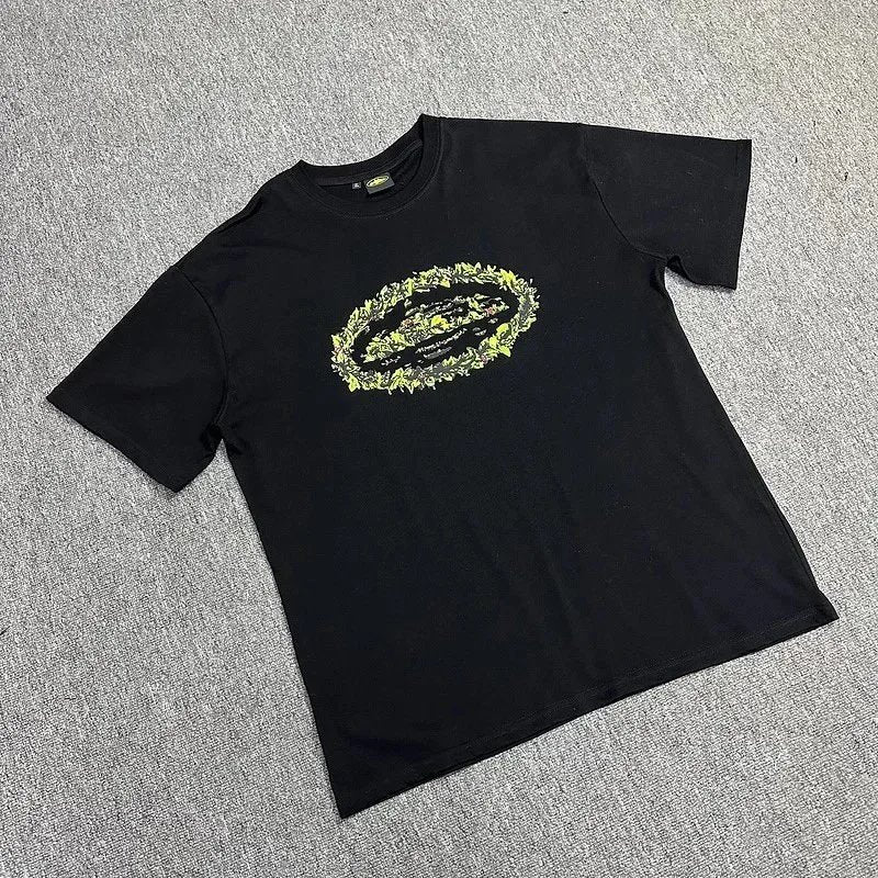 Black t-shirt with a floral graphic design on a gray textured background
