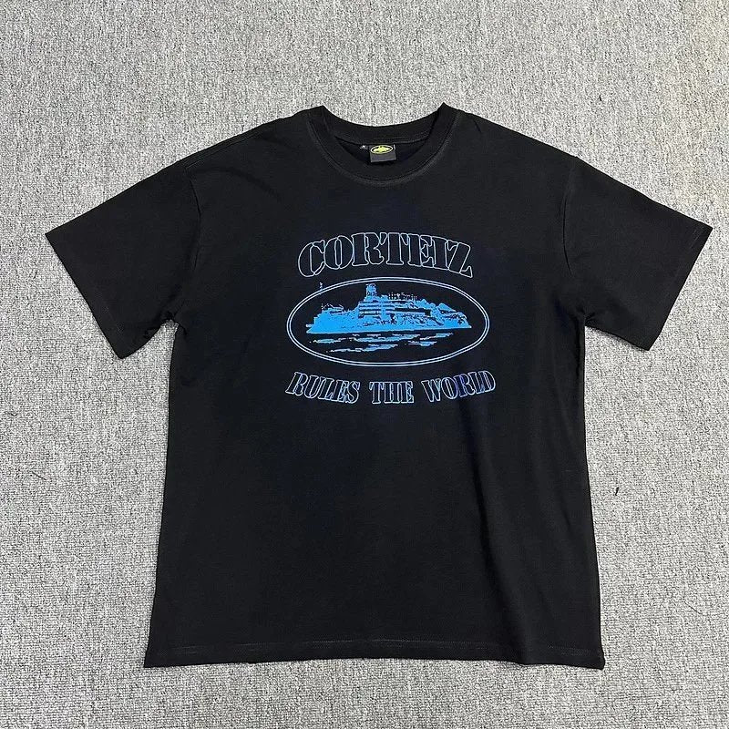 Black t-shirt with blue graphic and text on a gray textured background