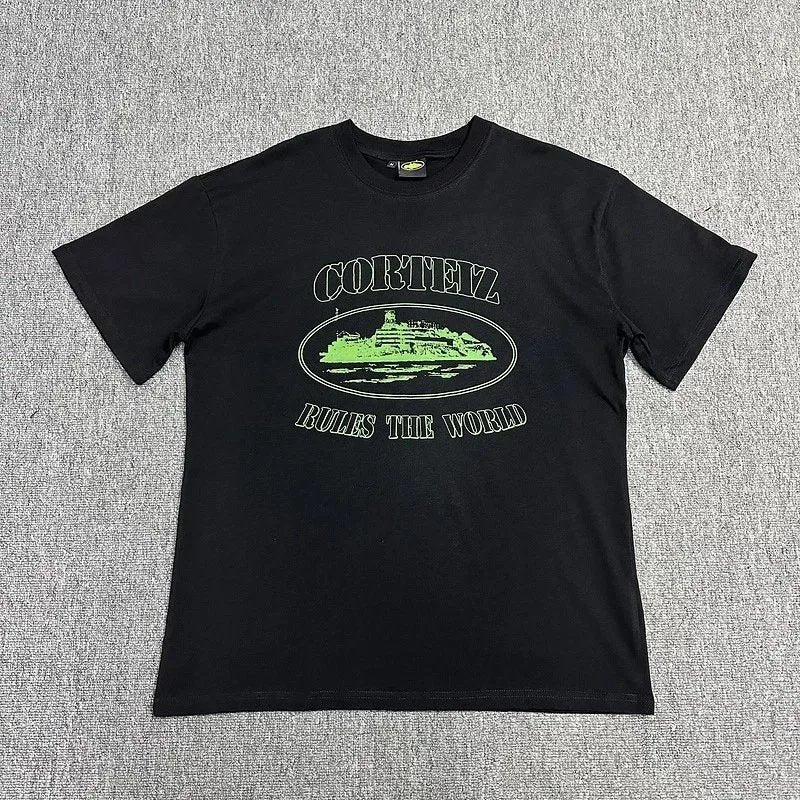 Black t-shirt with green graphic and text on a gray background