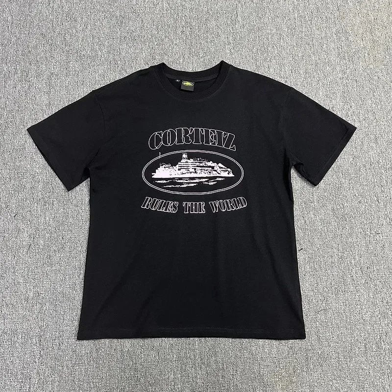Black t-shirt with white graphic and text on a gray textured background