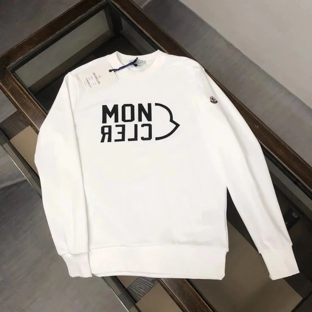 White sweatshirt with text and graphic design on a dark surface