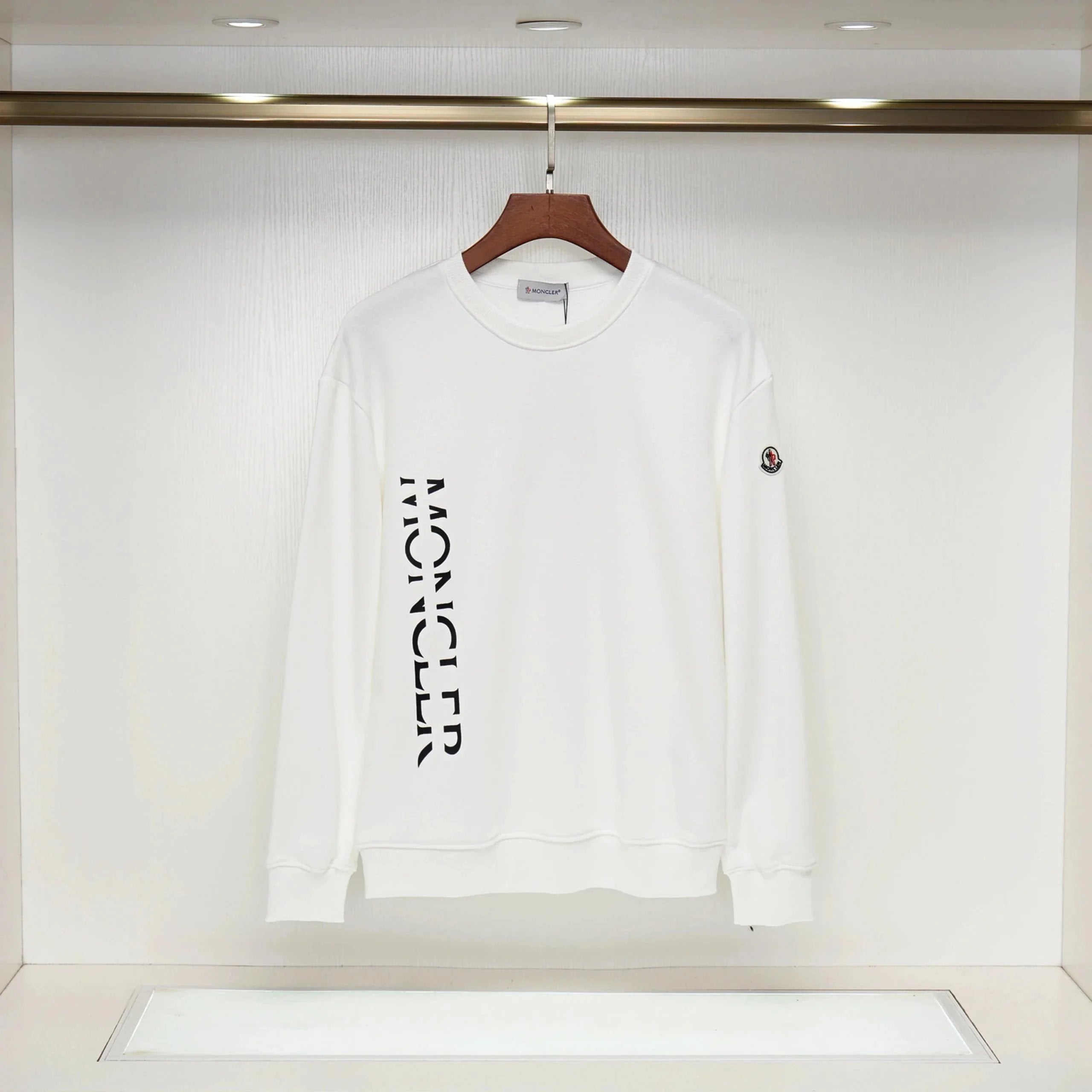 White sweatshirt with black text on a hanger against a white background