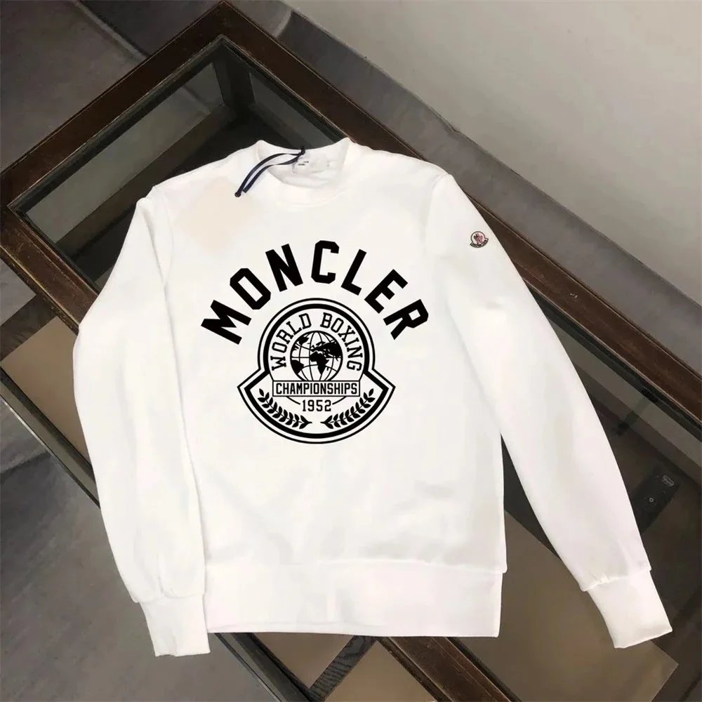White sweatshirt with black logo on a wooden surface