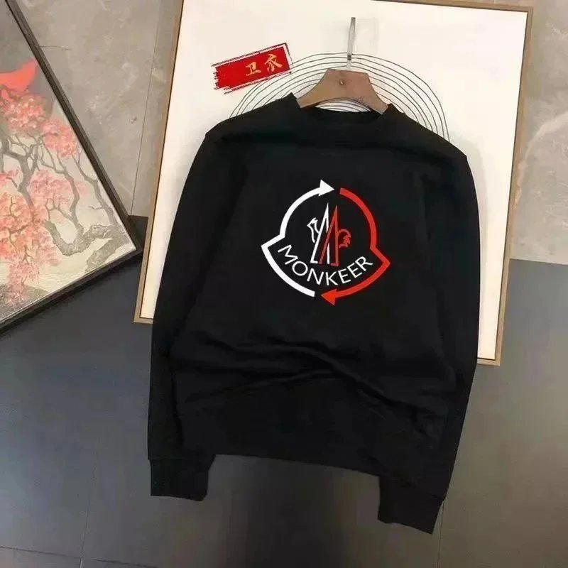 Black sweatshirt with a logo on a hanger against a neutral background