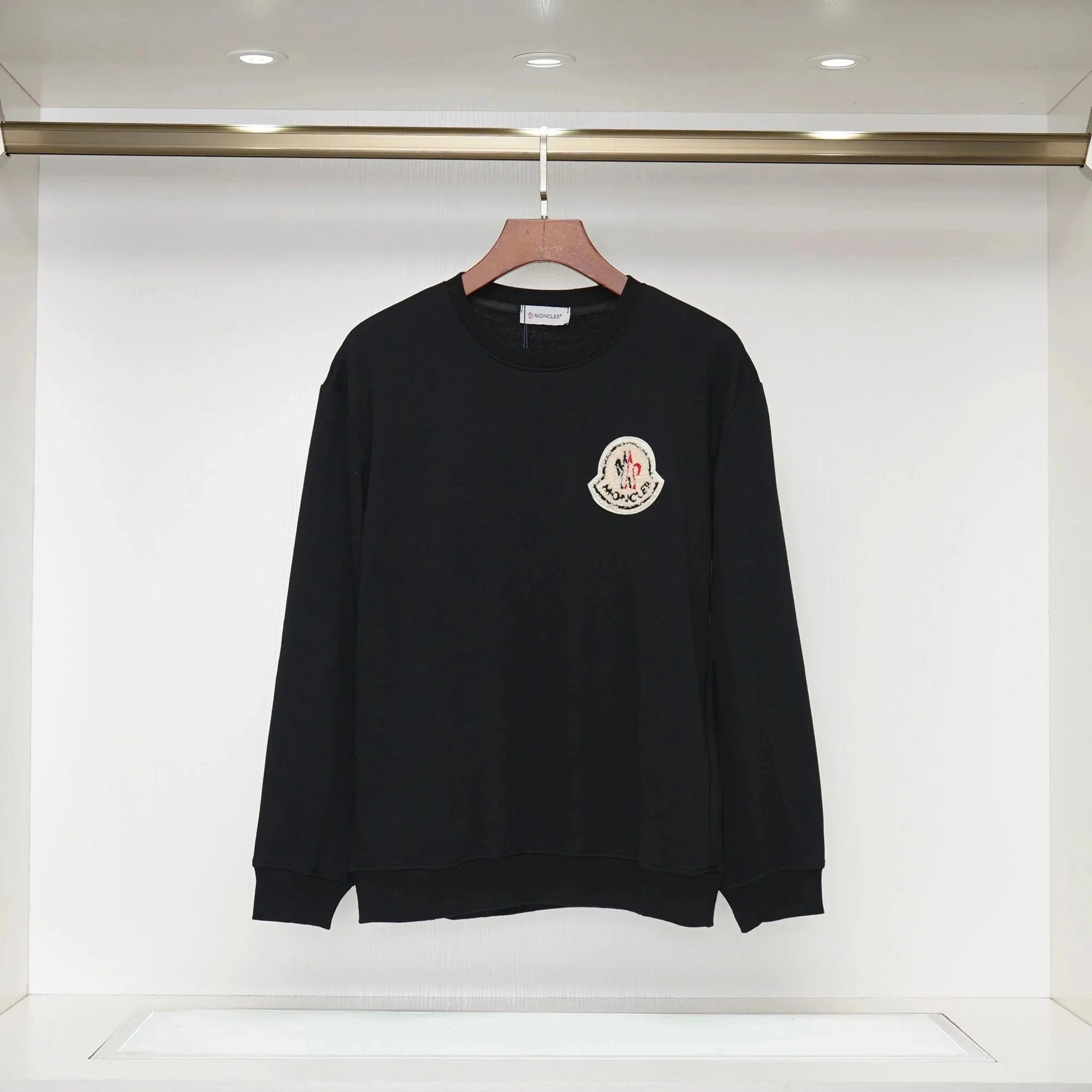Black sweater with a logo on a white background