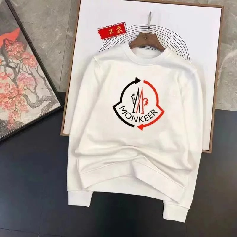 White sweatshirt with a logo on a dark surface