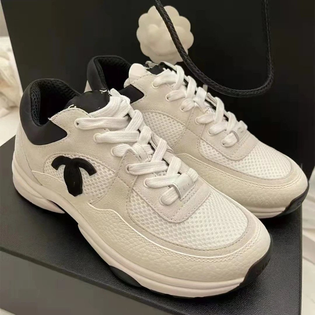 White sneakers with black accents on a dark surface