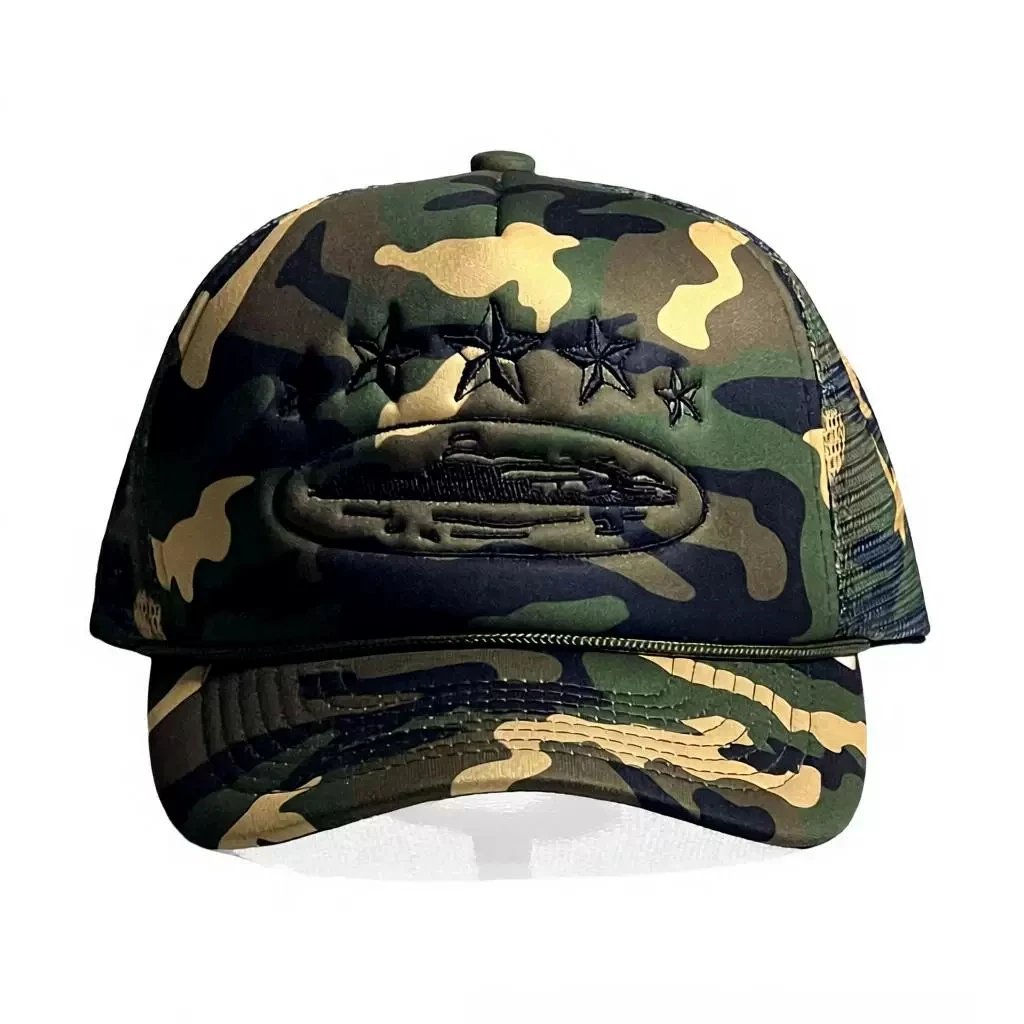 A camouflage trucker cap with a green, black, and tan pattern, featuring an embroidered military-style insignia with three stars and a ship on the front panel.