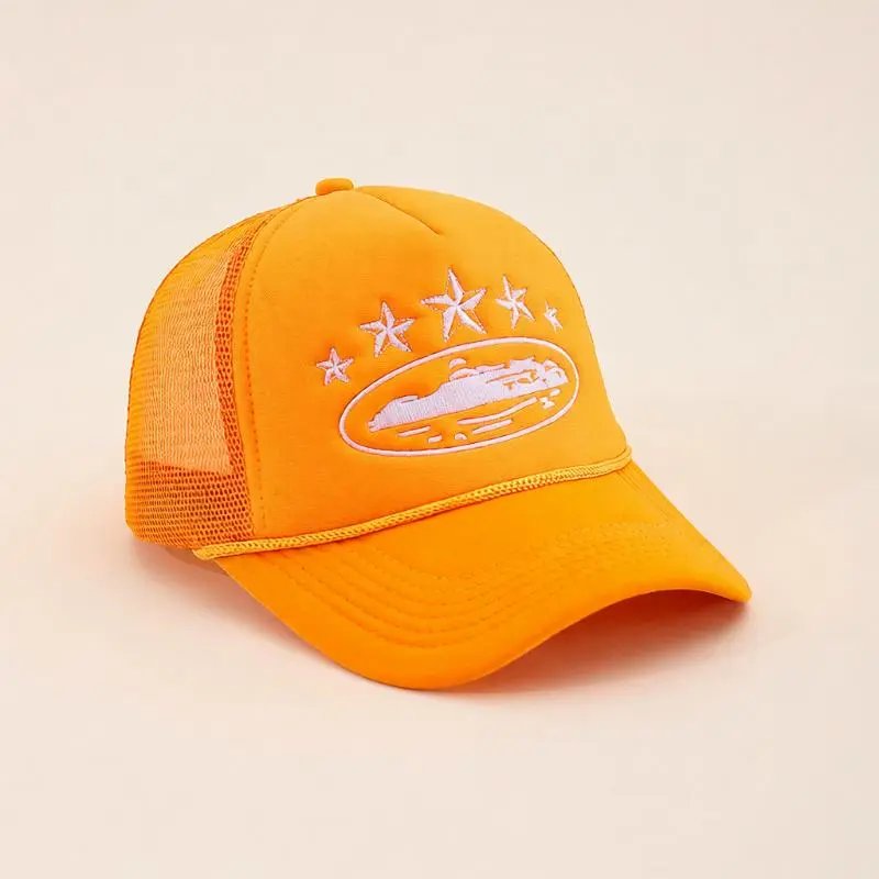 A bright orange trucker hat with a white embroidered logo of a boat surrounded by stars on the front panel, set against a plain beige background.