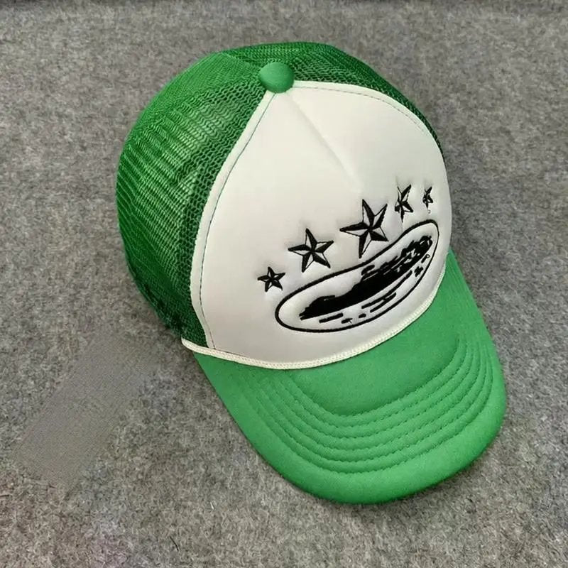 A green and white trucker hat with a white front panel, green mesh back, and a black embroidered graphic of a hot dog with stars on the front.