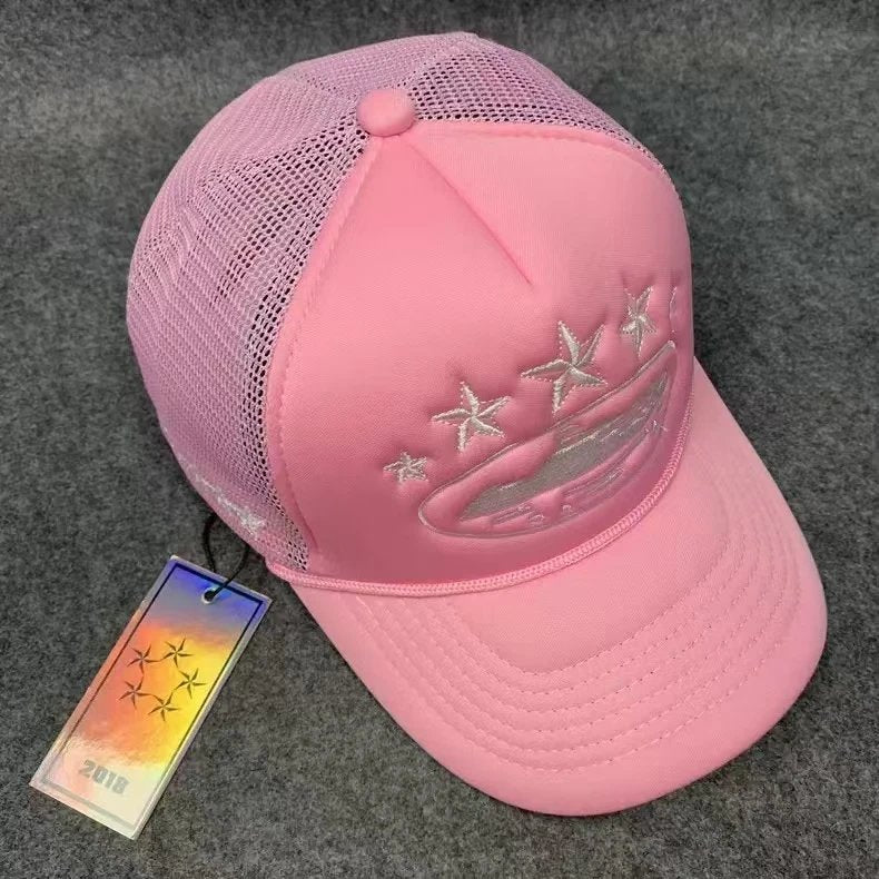 Pink cap with starfish and wave design on a gray surface