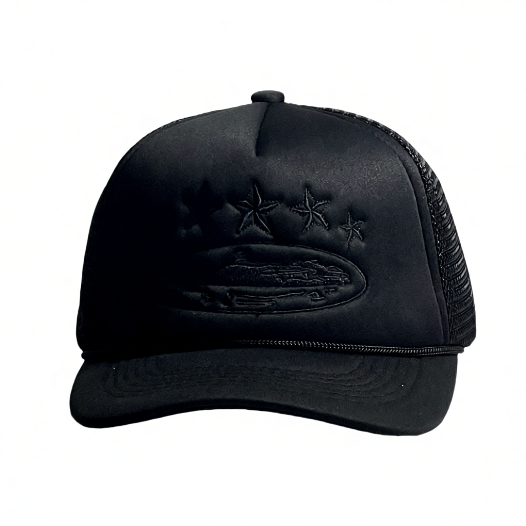 A black trucker hat with a structured front panel, black mesh back, and an embossed graphic featuring four stars and a ship on the brim.