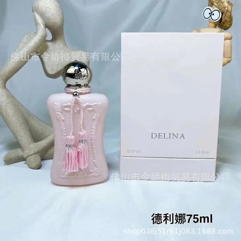 Pink perfume bottle with decorative elements and white box labeled 'DELINA' on a light gray background.