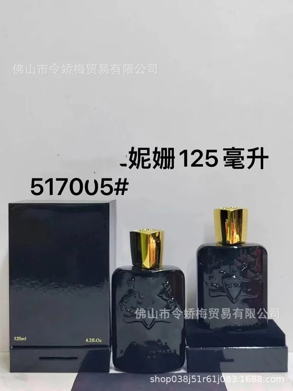 Two black perfume bottles with gold caps on a light gray background