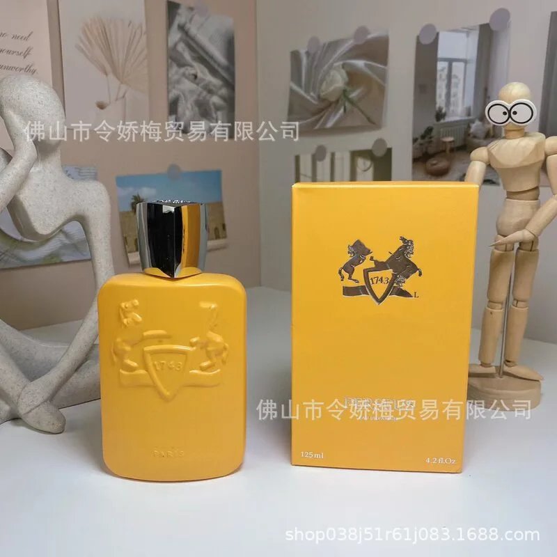 Yellow bottle and box with a logo on a white surface