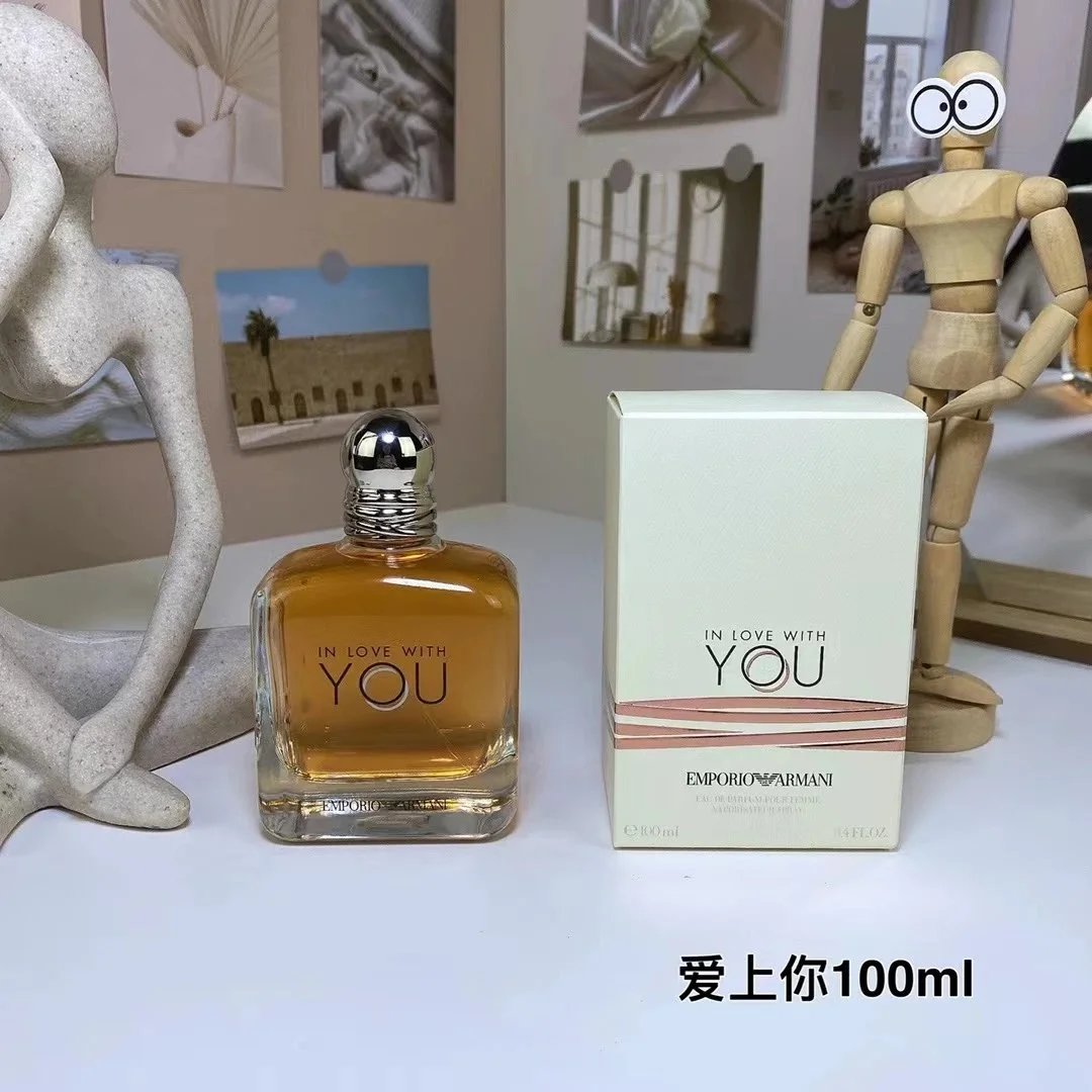 Emilio Pucci perfume bottle and box on a table with decorative items in the background
