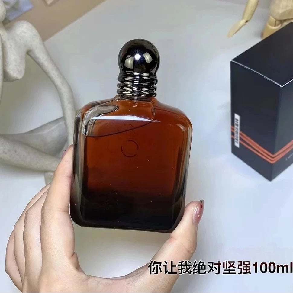 Brown bottle held by a hand with a box labeled 'YO' in the background