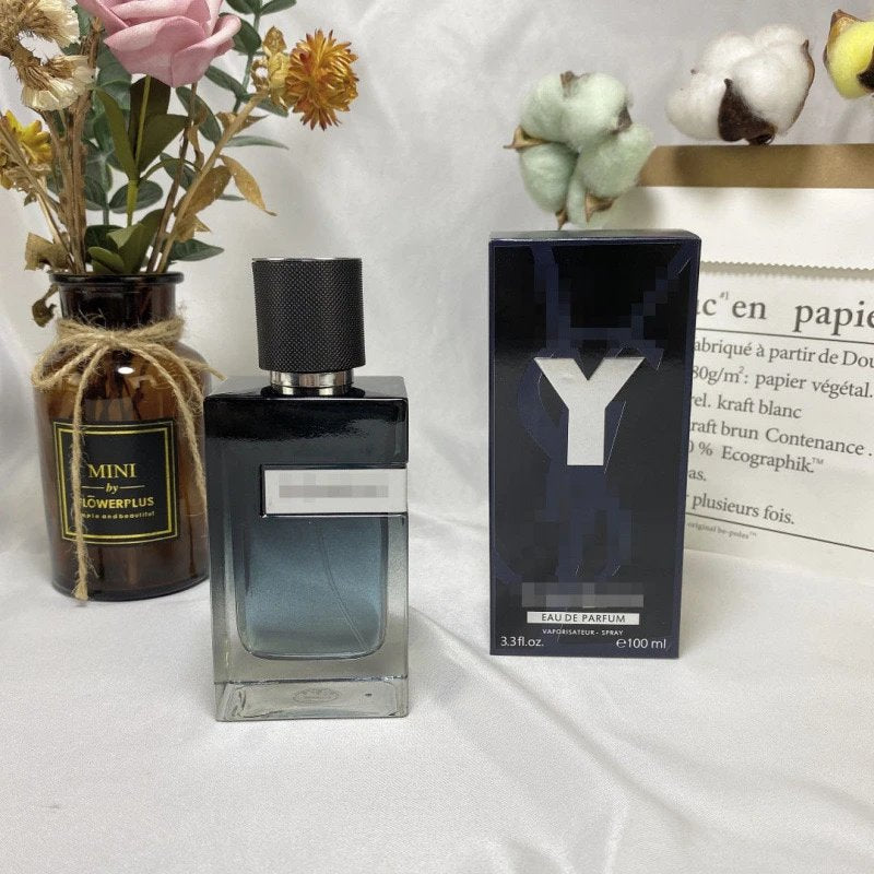 Perfume bottle and packaging with decorative elements on a light background