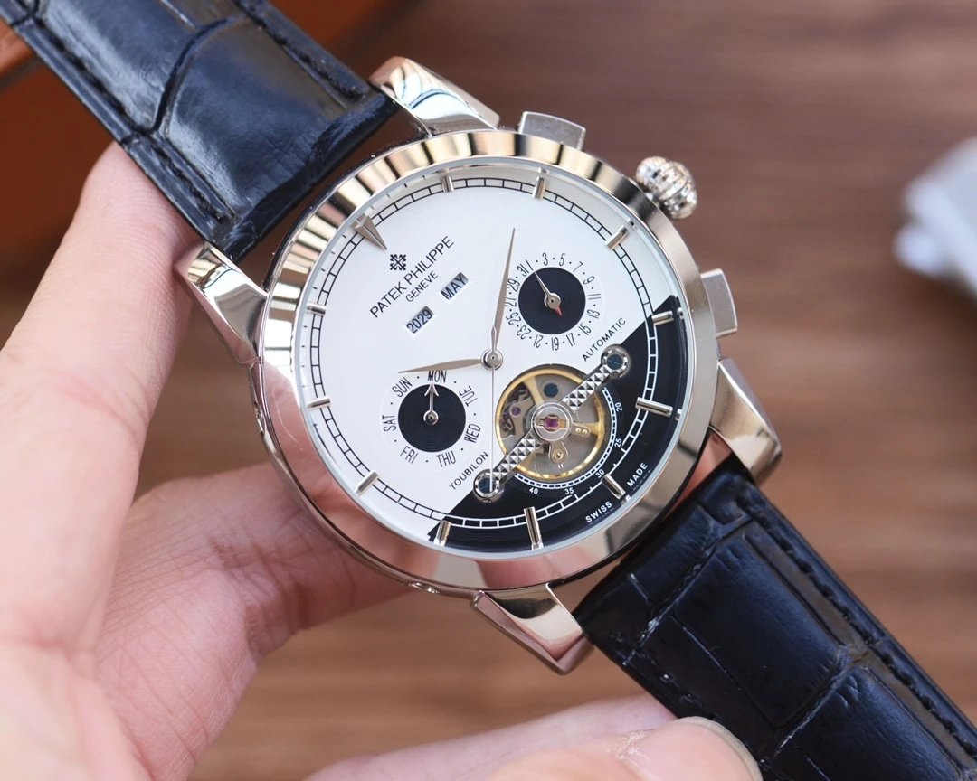 Close-up of a luxury watch with a visible brand name, held in a hand against a blurred background.