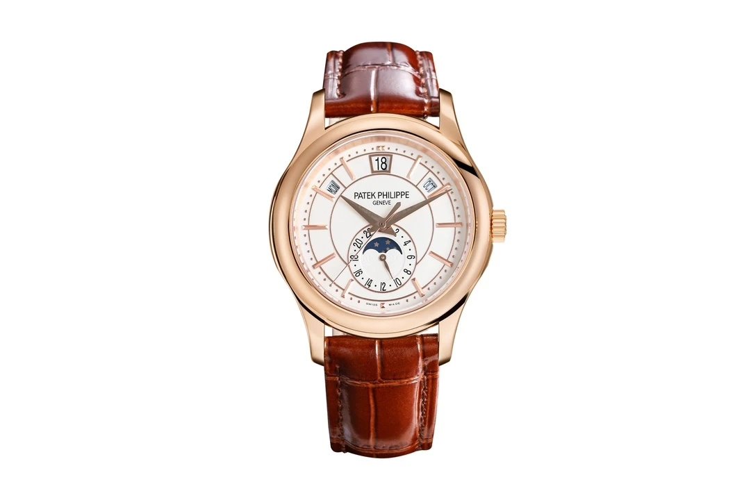 Patek Philippe watch with brown leather strap on a white background
