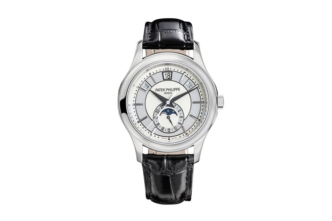 Watch with black leather strap and silver case on a white background