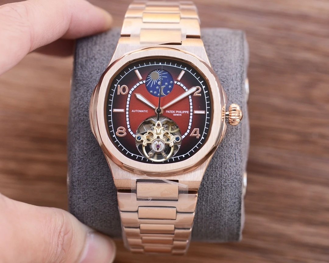 Rose gold watch with a detailed face on a gray stand against a wooden background