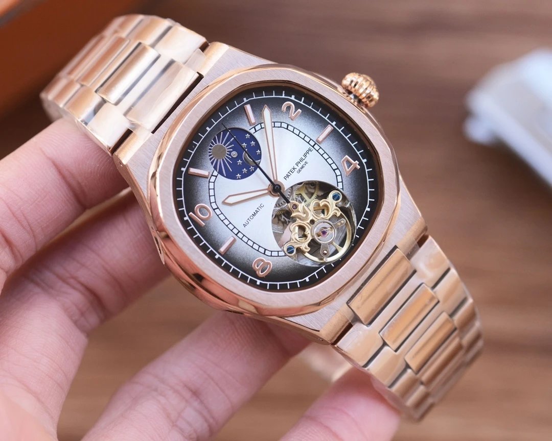 Rose gold wristwatch with detailed face held in a hand against a blurred background