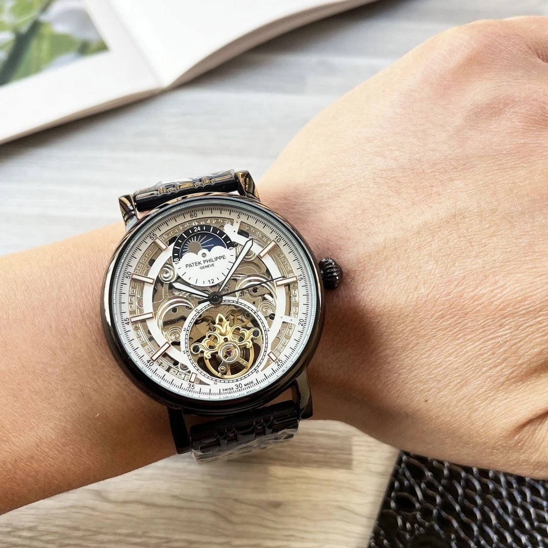 Close-up of a wrist wearing a detailed wristwatch with a blurred background